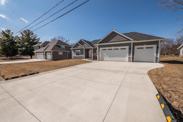 view of front of home featuring a garage, stone siding, and concrete driveway