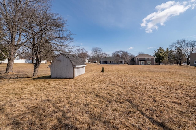 view of yard featuring an outbuilding and a shed