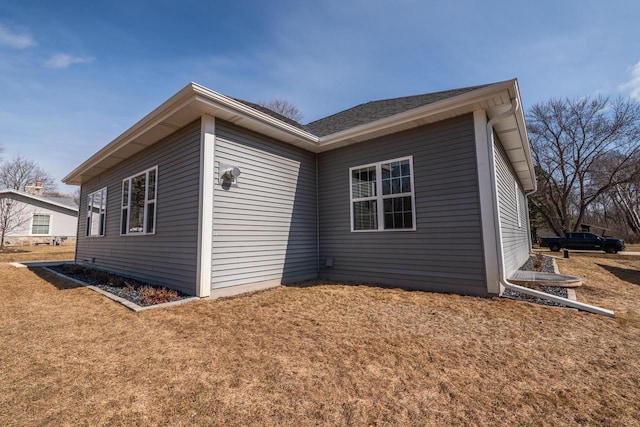 view of side of property with a lawn