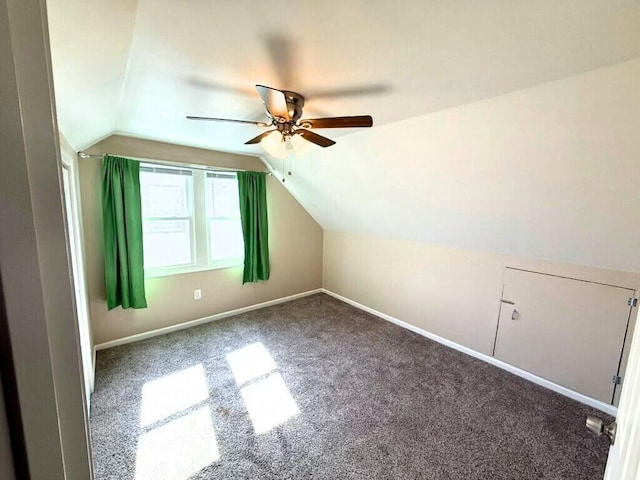 bonus room featuring vaulted ceiling, carpet, baseboards, and ceiling fan