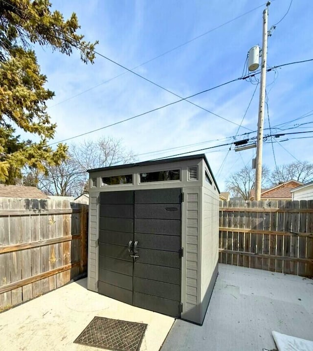 view of shed featuring fence private yard