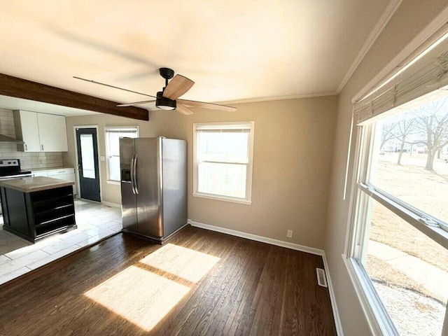 kitchen with plenty of natural light, stainless steel fridge, electric range oven, and wood finished floors