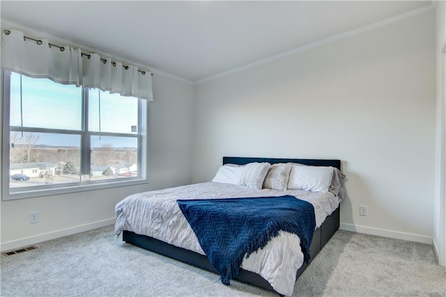 bedroom with visible vents, baseboards, carpet floors, and ornamental molding