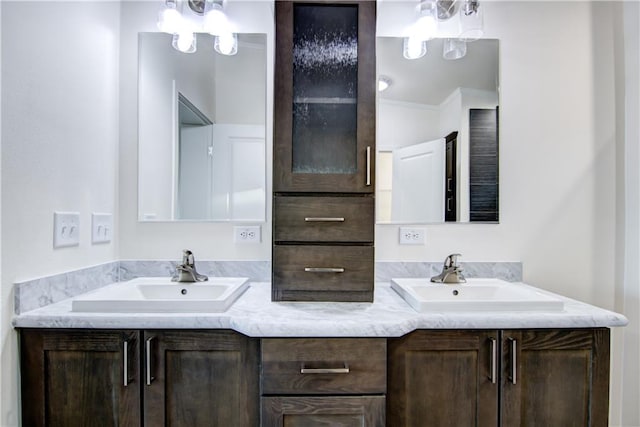 full bathroom with double vanity and a sink