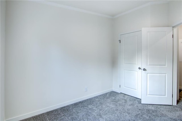 unfurnished bedroom with baseboards, carpet floors, and ornamental molding