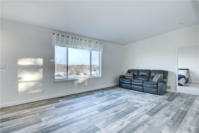 living area featuring wood finished floors and baseboards