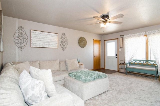 carpeted living area featuring a ceiling fan