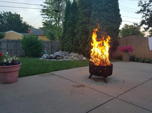 view of patio featuring a fire pit and fence