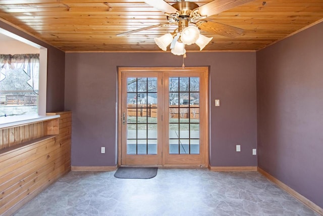 doorway to outside featuring a wealth of natural light, wood ceiling, and baseboards