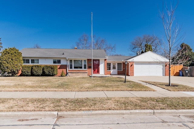 ranch-style house with brick siding, fence, concrete driveway, a front yard, and a garage