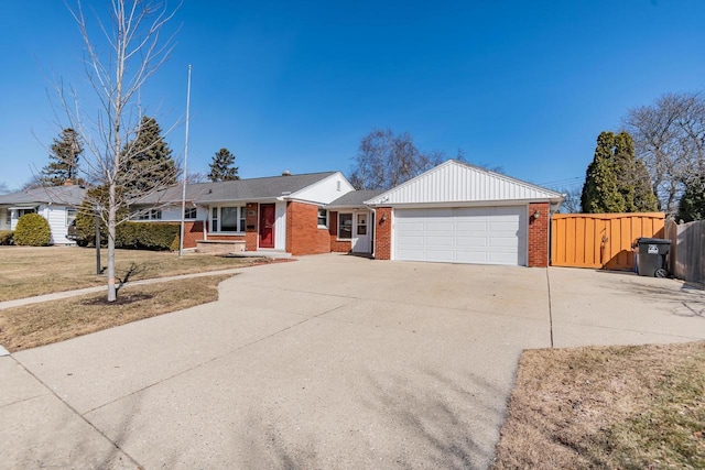 single story home featuring driveway, a gate, fence, an attached garage, and brick siding