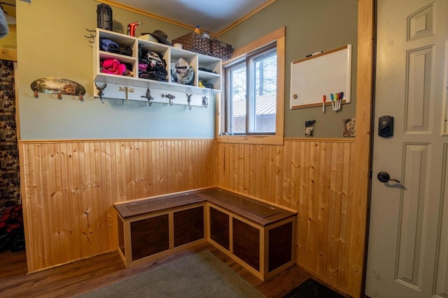 mudroom with wooden walls, wood finished floors, wainscoting, and crown molding