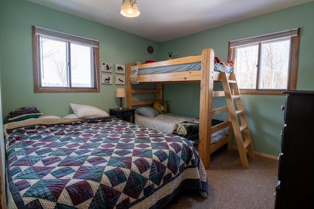 carpeted bedroom with multiple windows and baseboards