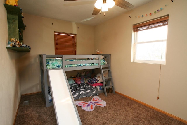 carpeted bedroom featuring baseboards and ceiling fan