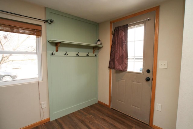 entryway featuring baseboards and dark wood-style flooring