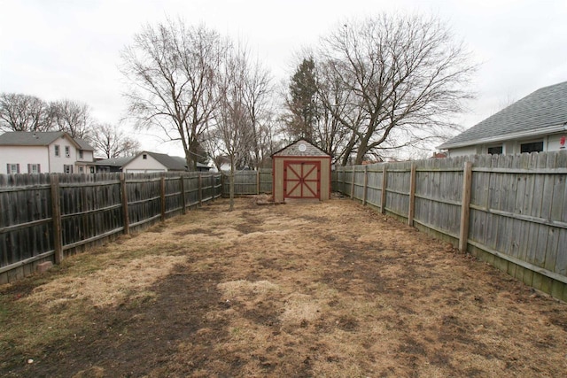 view of yard featuring a fenced backyard, a shed, and an outdoor structure