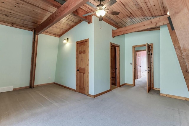 interior space featuring vaulted ceiling with beams, baseboards, and carpet floors