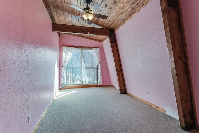 spare room featuring lofted ceiling with beams, carpet, wooden ceiling, and a textured wall