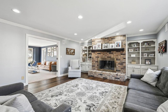 living room featuring dark wood-style floors, recessed lighting, a fireplace, crown molding, and baseboards