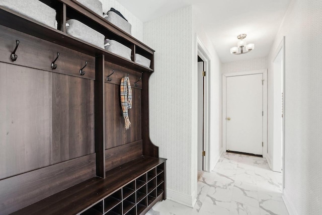 mudroom with baseboards and marble finish floor