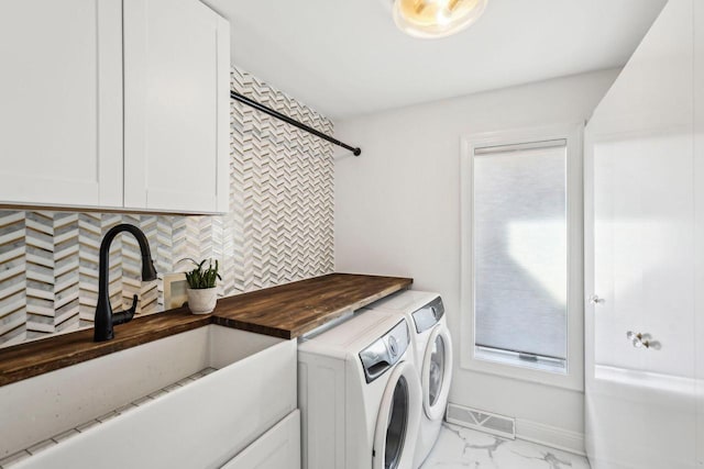 laundry area with a sink, baseboards, marble finish floor, and washer and clothes dryer