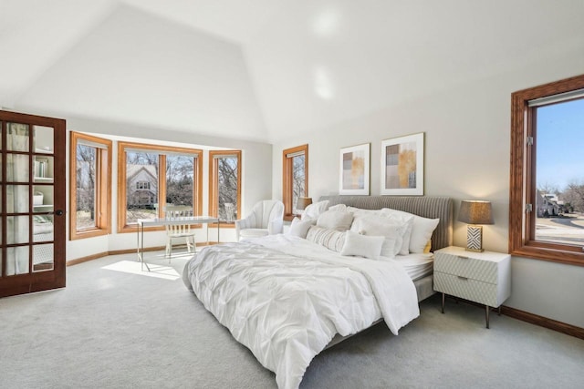 carpeted bedroom with baseboards and high vaulted ceiling