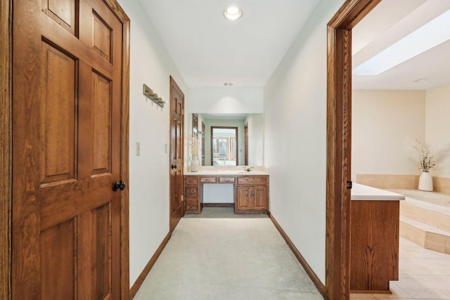 hallway featuring baseboards