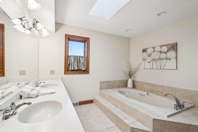 full bath featuring tile patterned flooring, a skylight, a garden tub, and a sink