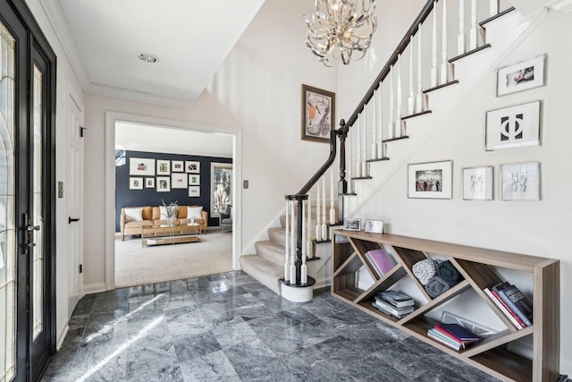 entryway with a notable chandelier, marble finish floor, ornamental molding, stairway, and baseboards