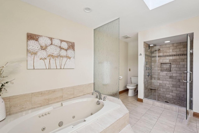 full bathroom with a tub with jets, a skylight, a shower stall, tile patterned floors, and toilet