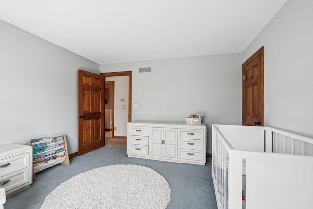 carpeted bedroom with visible vents and baseboards