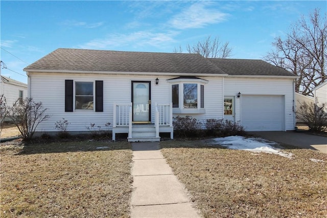 ranch-style house with a front lawn, concrete driveway, a garage, and roof with shingles