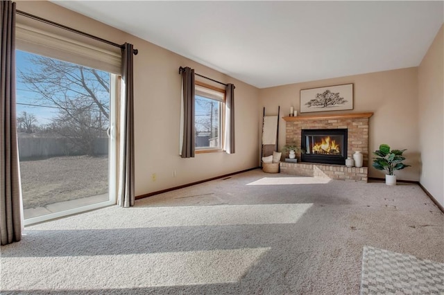 unfurnished living room featuring baseboards, carpet, and a fireplace