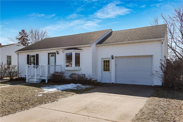 single story home with driveway, roof with shingles, and an attached garage