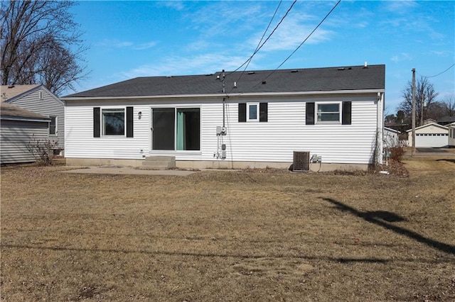 rear view of property with central air condition unit, entry steps, a yard, and roof with shingles