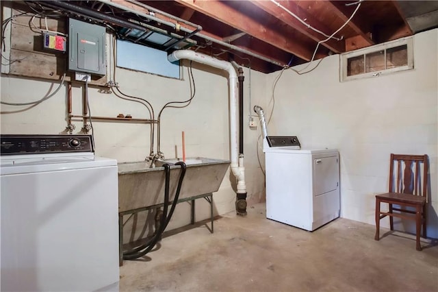 washroom with laundry area, electric panel, and separate washer and dryer