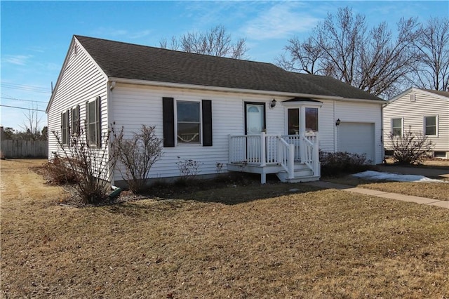 single story home featuring an attached garage, a shingled roof, and a front lawn