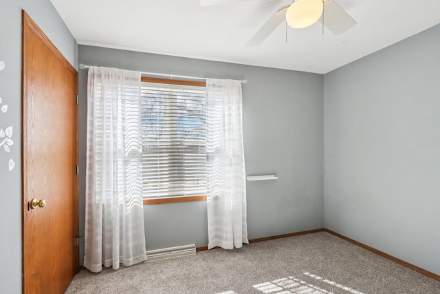 spare room featuring carpet flooring, a ceiling fan, and baseboards