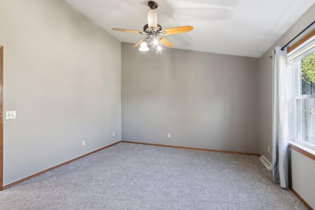 carpeted empty room with baseboards and ceiling fan