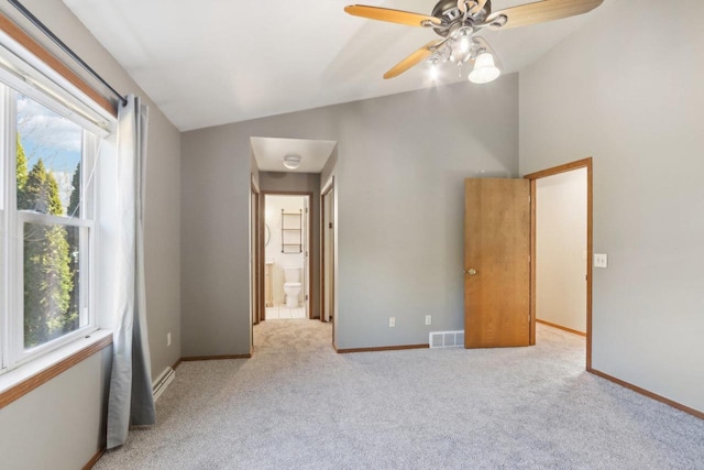 unfurnished bedroom featuring visible vents, multiple windows, carpet, and lofted ceiling