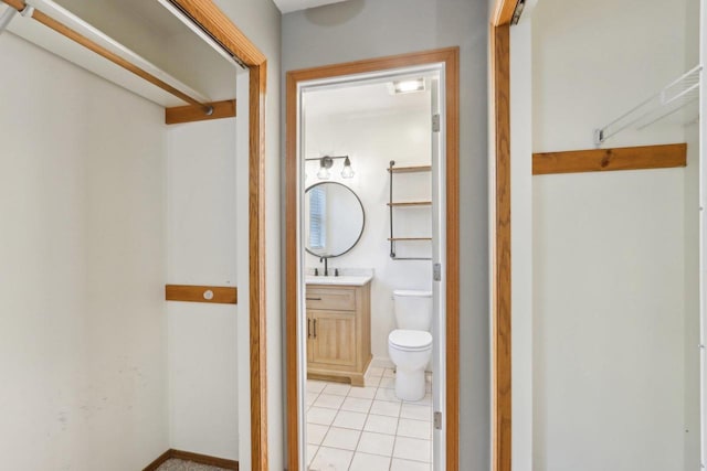 bathroom featuring tile patterned floors, a shower, toilet, and vanity