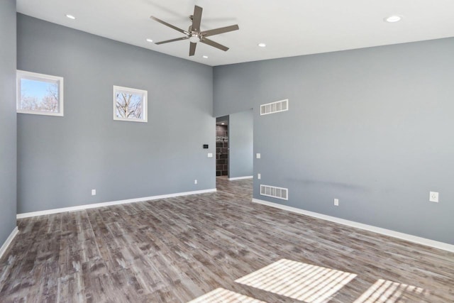 spare room with wood finished floors, baseboards, visible vents, recessed lighting, and ceiling fan