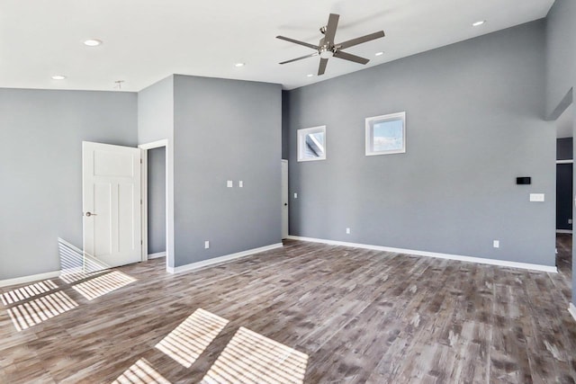 spare room with ceiling fan, baseboards, wood finished floors, and recessed lighting