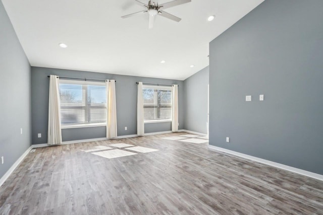 unfurnished room with baseboards, a healthy amount of sunlight, and wood finished floors