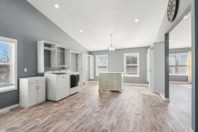 kitchen with independent washer and dryer, baseboards, light countertops, and light wood-style floors