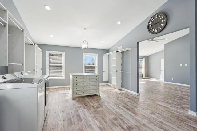 interior space featuring laundry area, washing machine and dryer, light wood-type flooring, and baseboards