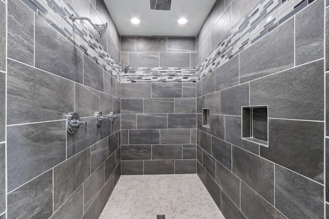 full bathroom with visible vents and tiled shower