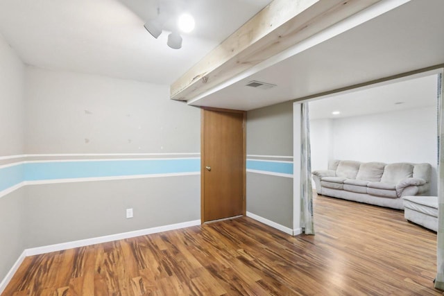 interior space featuring visible vents, baseboards, and wood finished floors