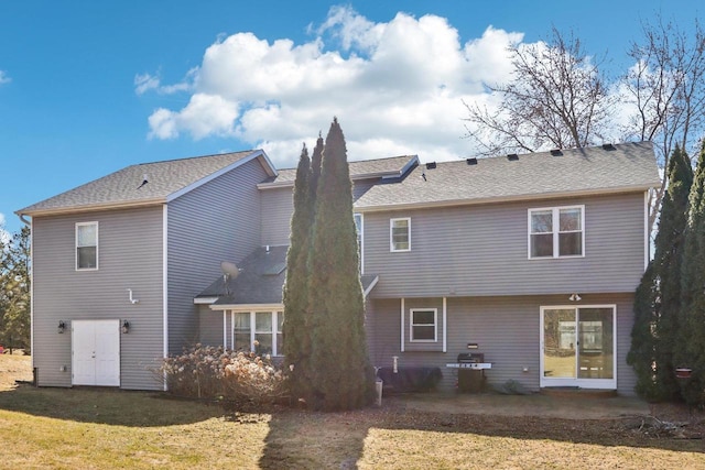 back of house featuring a patio and a lawn