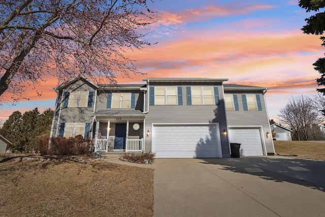 view of front of property with a garage, covered porch, and driveway